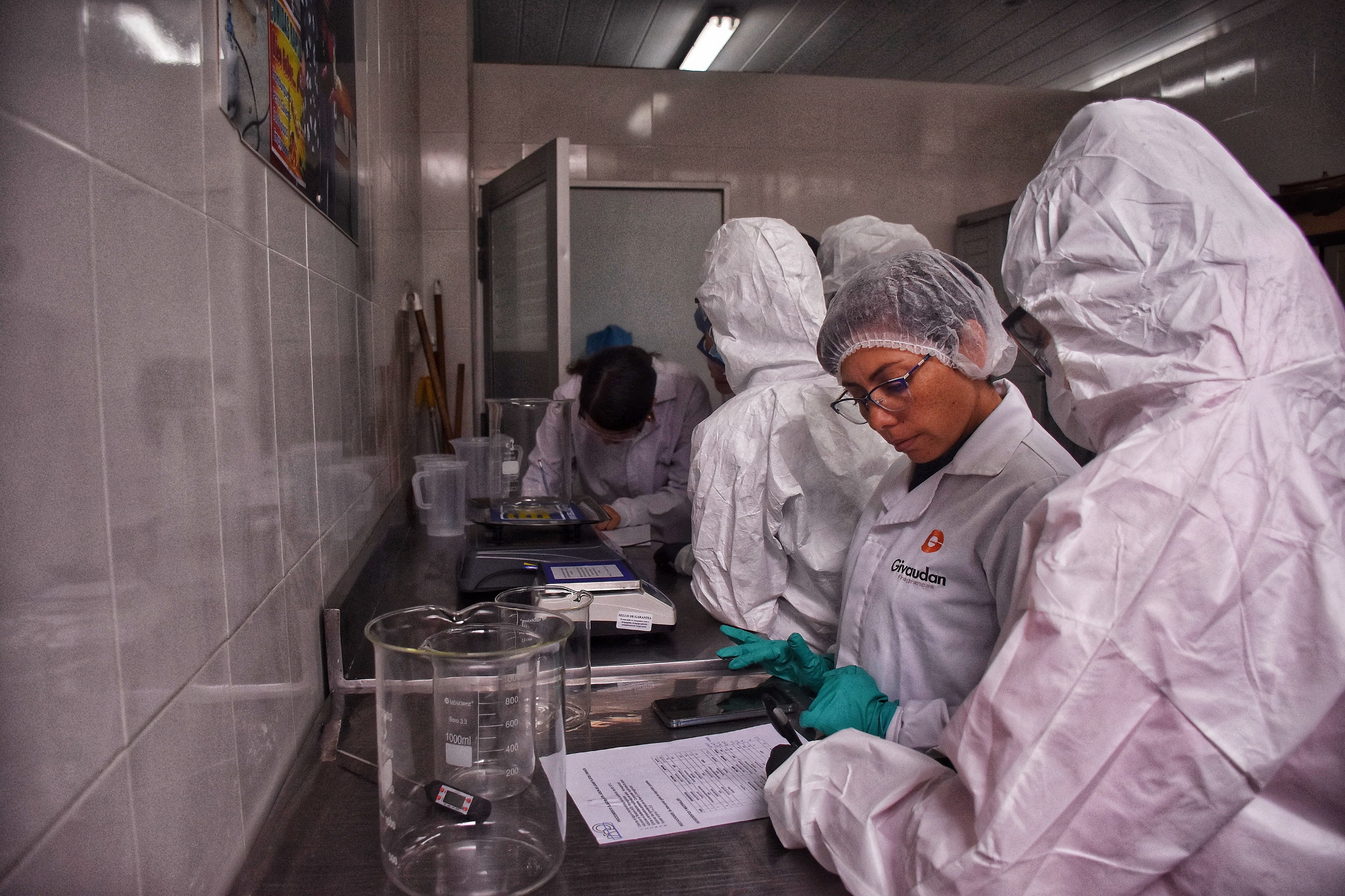 volunteers together with participants in a lab manufacturing cleaning products