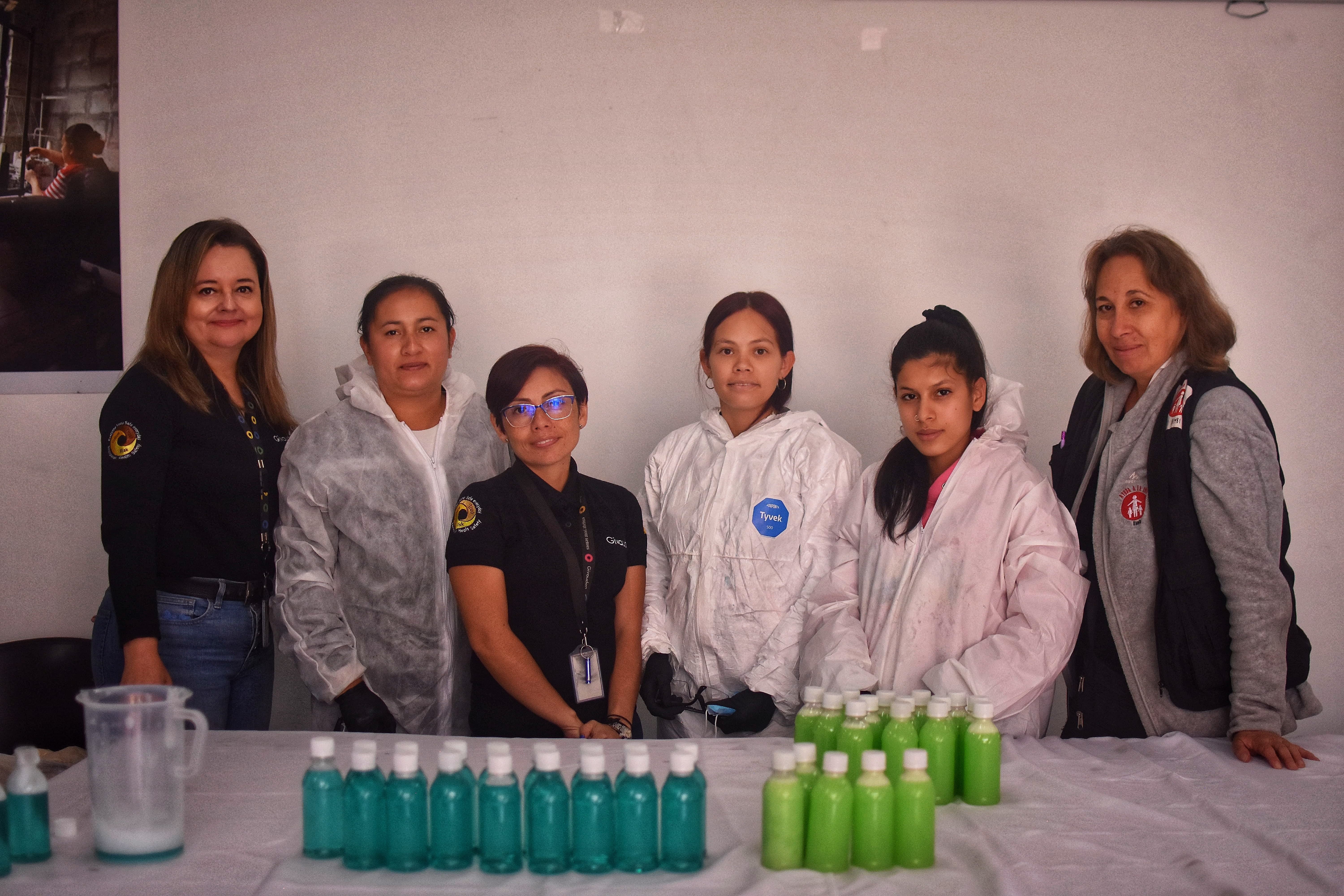 volunteers together with participants posing with their cleaning products