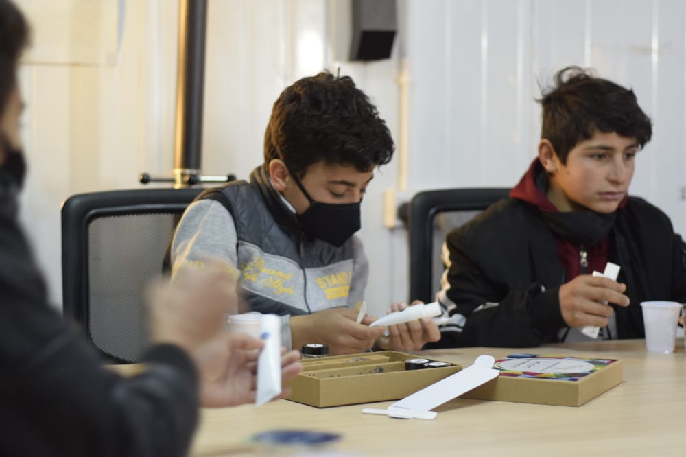 teenage boy during an oral care awareness campaign fabricating his toothpaste