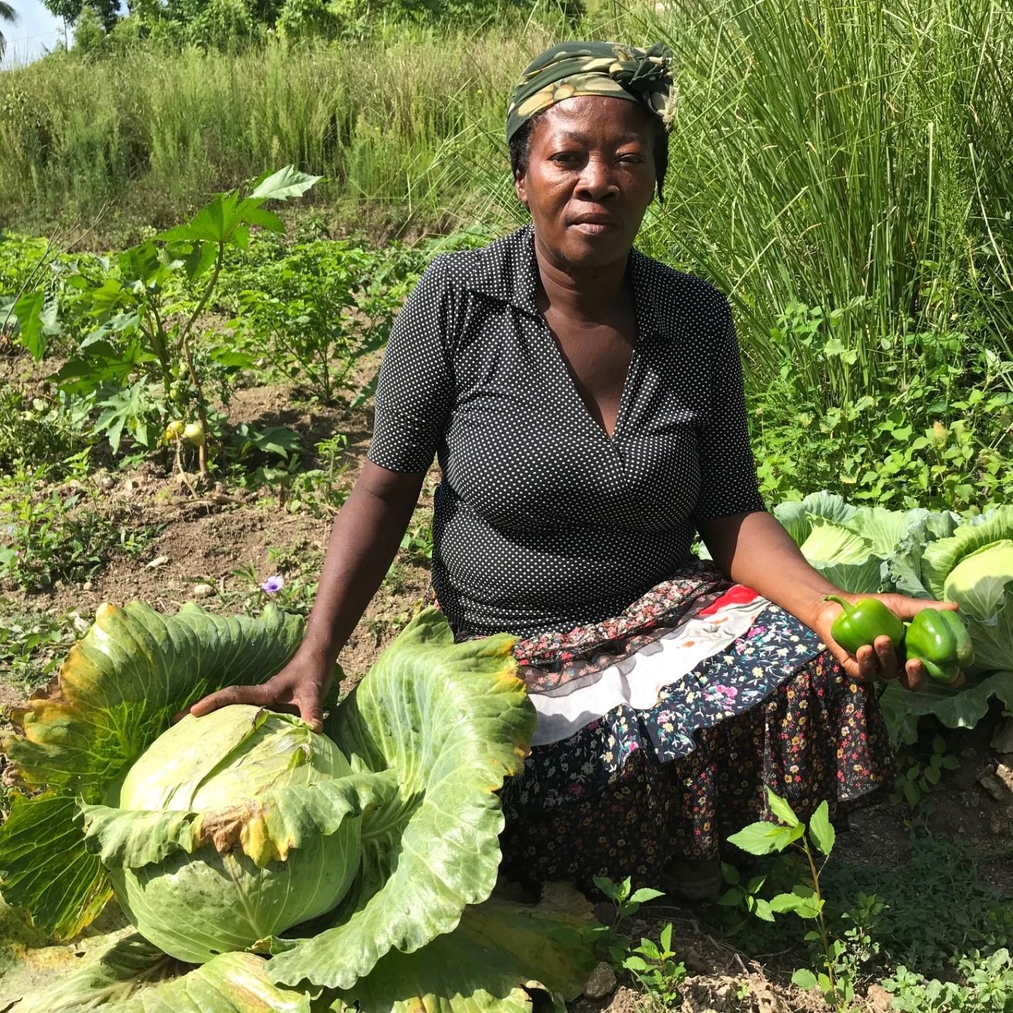 Woman from Haiti seating on a garden