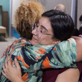 two project beneficiaries holding